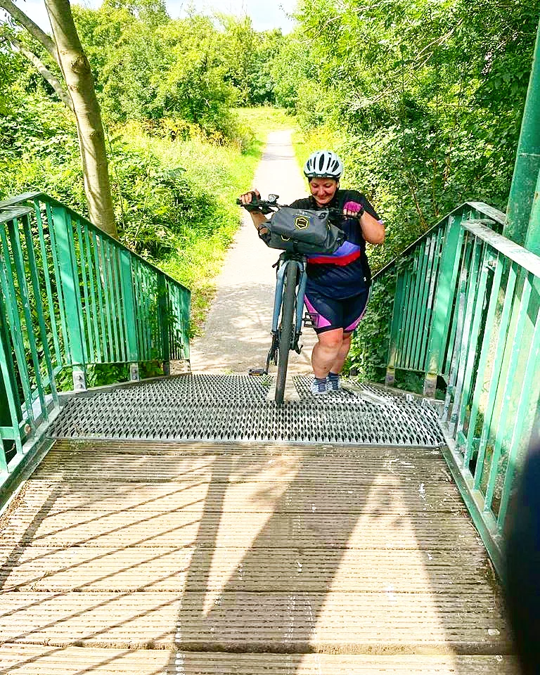 Fahrrad wird Treppe hoch geschoben.