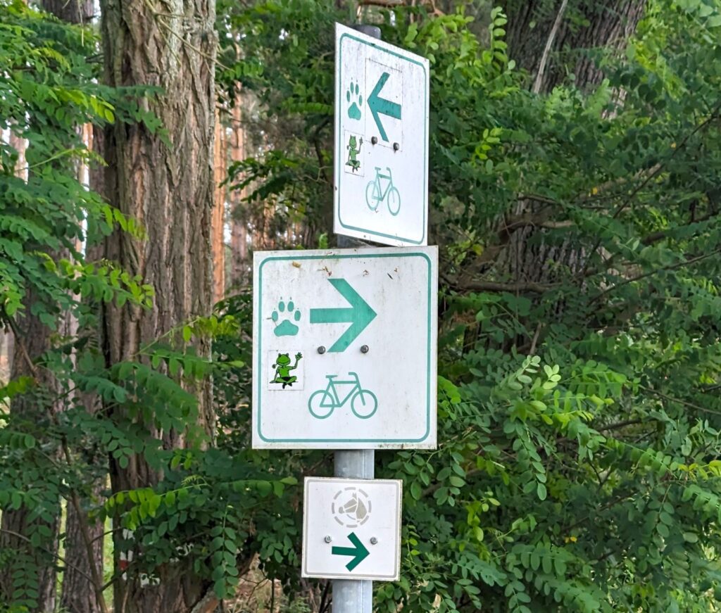 Wegbeschilderung für den Froschradweg. Ein winkender Frosch.